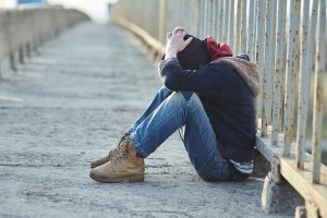 Image of homeless boy looking distressed