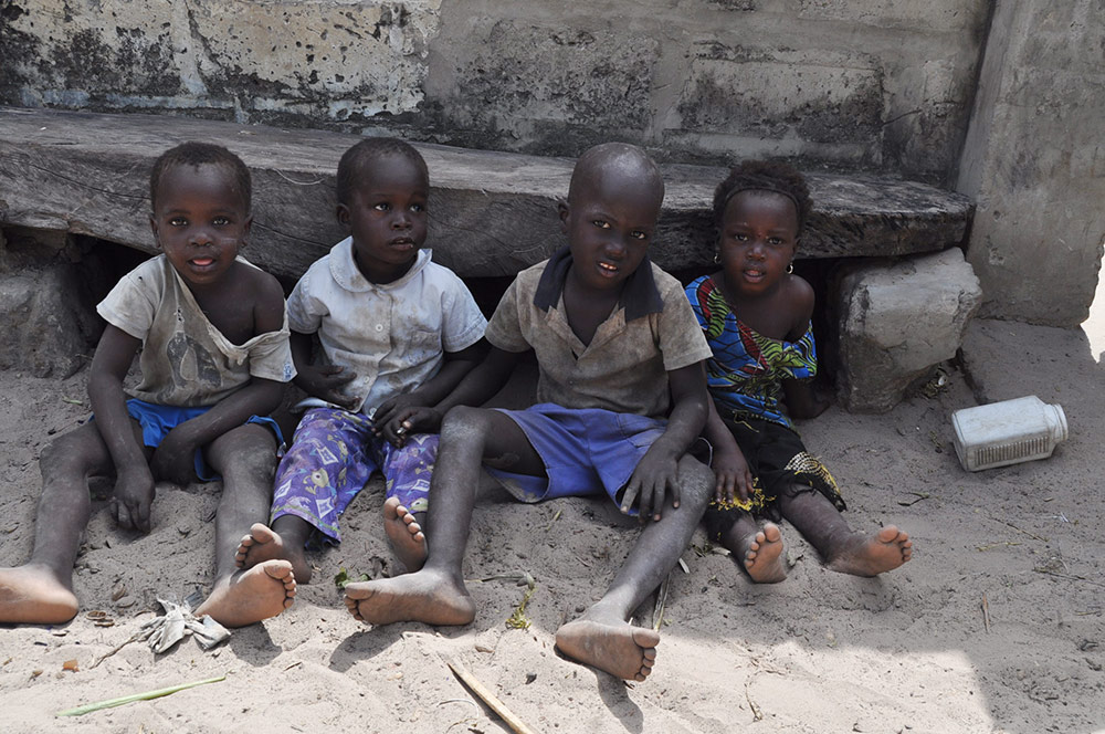 Children in Gambia sitting on the floor